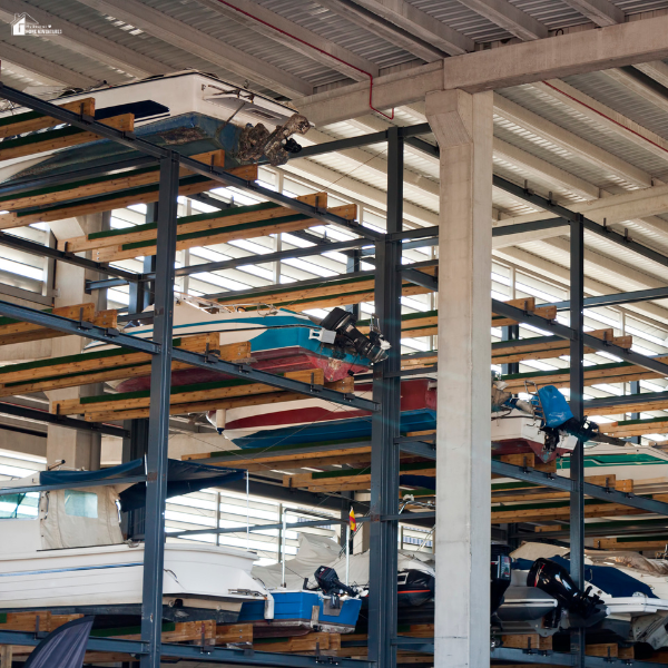 Multiple boats stacked on indoor storage racks show a protected option families can use to keep their watercraft safe before winter.