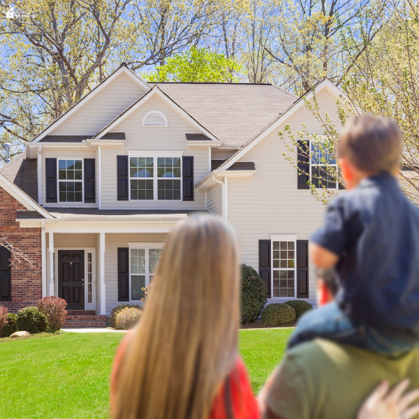 A family looks at their house, symbolizing the importance of managing home repairs, maintenance, and upgrades together.