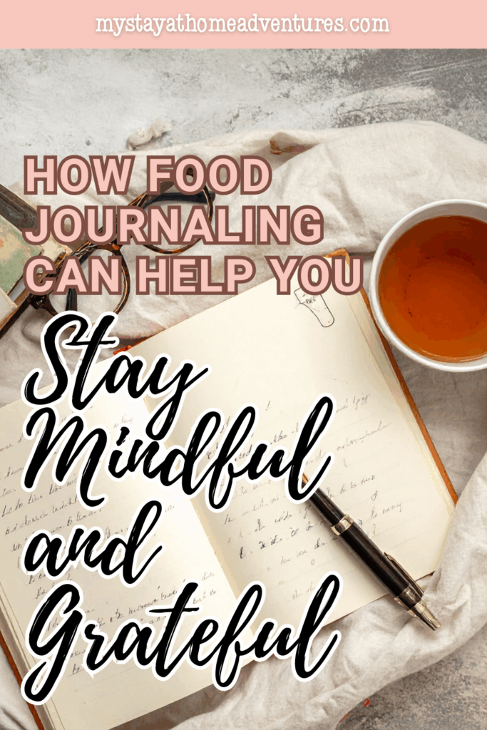 An open journal with handwritten notes sits beside a cup of tea, representing mindful food journaling and gratitude practices.