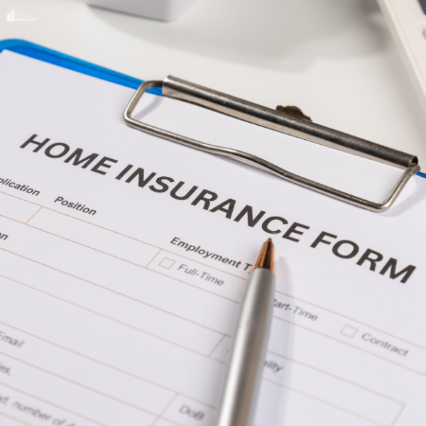 A close-up of a home insurance form with a pen placed on top, emphasizing how proper roof care can influence insurance costs and overall home value.