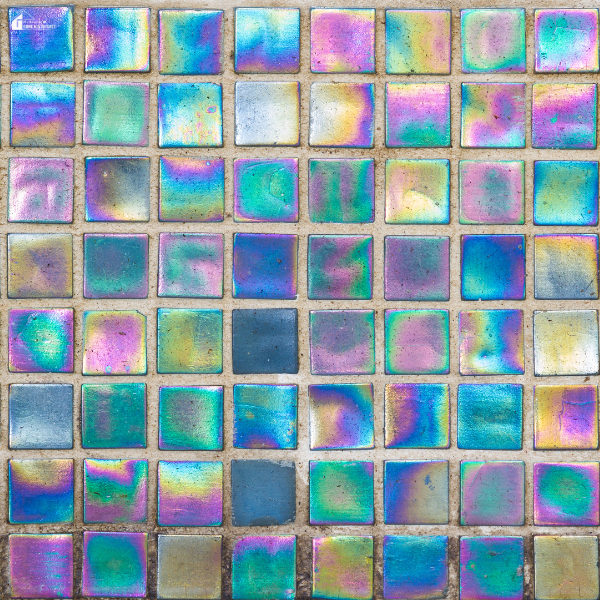 Close-up view of colorful glass mosaic tiles arranged in a grid pattern.