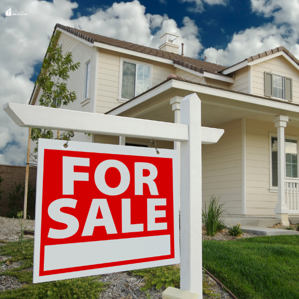 A front-yard “For Sale” sign stands in front of a house, representing the first steps and decisions involved in selling a home.