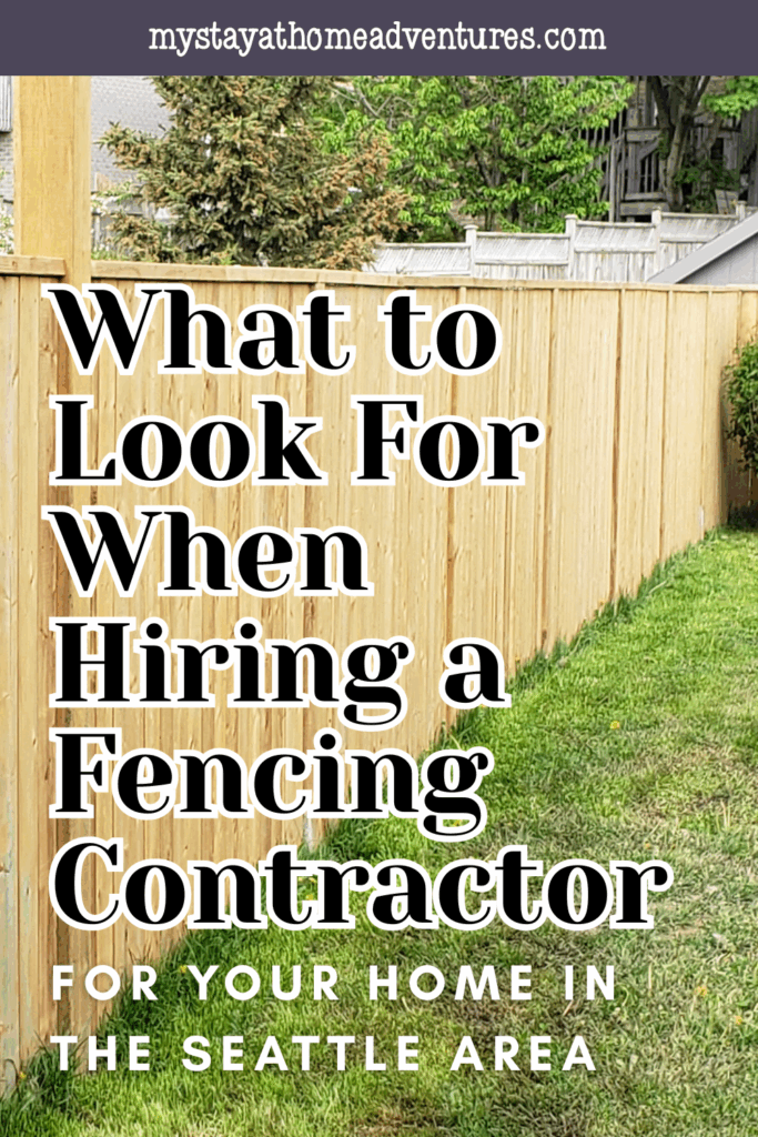 A newly installed vertical wood fence along a backyard with green grass and a tree-lined property line, ideal for privacy and home security.