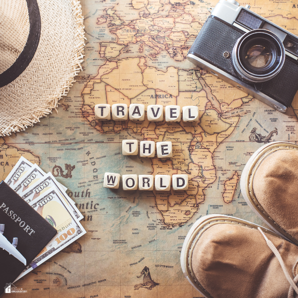 A flat lay of travel essentials including a map, passport, money, camera, and shoes, suggesting budget-friendly trip planning.