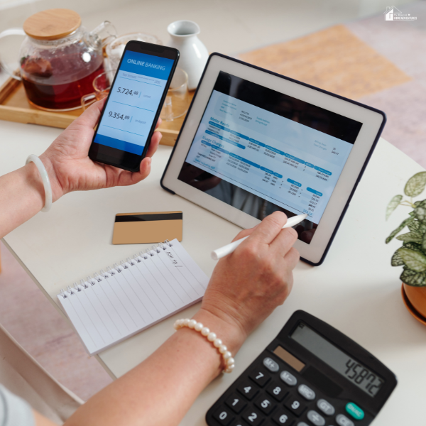 A person reviewing finances on a tablet and smartphone at home, showing how managing responsibilities digitally can simplify budgeting and scheduling.