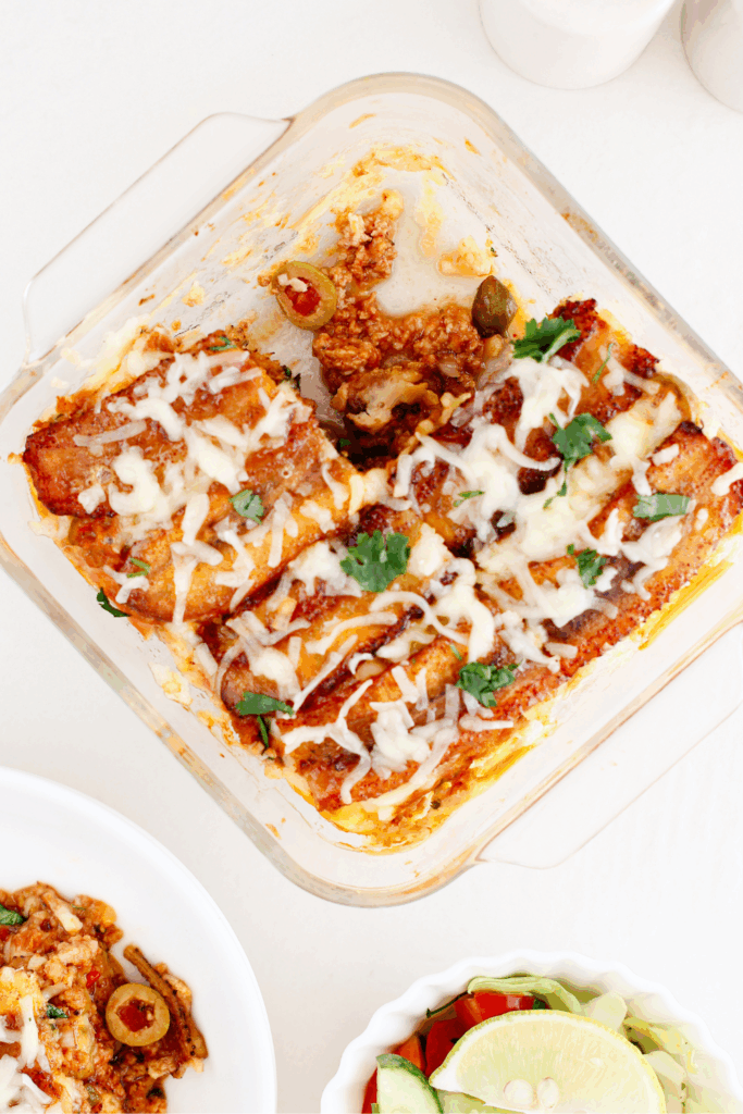 A freshly baked pastelón in a glass dish, showing layers of plantains, beef, and melted cheese.