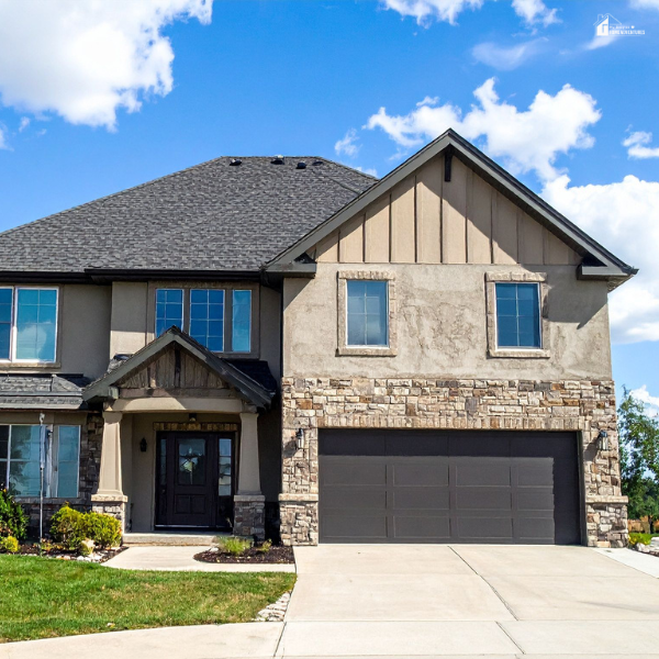 A modern home showcasing upgraded siding and stonework, reflecting exterior improvements that boost overall comfort and curb appeal.