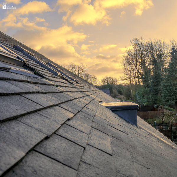 A close-up view of a residential roof at sunset, highlighting a key area of home maintenance often overlooked until damage occurs.