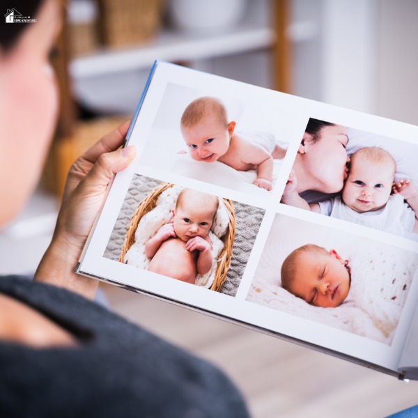 A person looks at a baby photo book filled with newborn portraits and family moments.