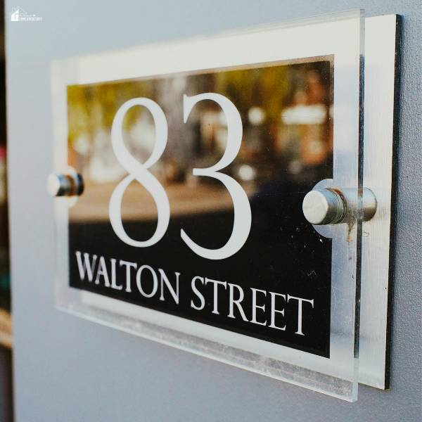 A modern house number sign near the front entry that shows how small exterior upgrades can quickly elevate curb appeal.
