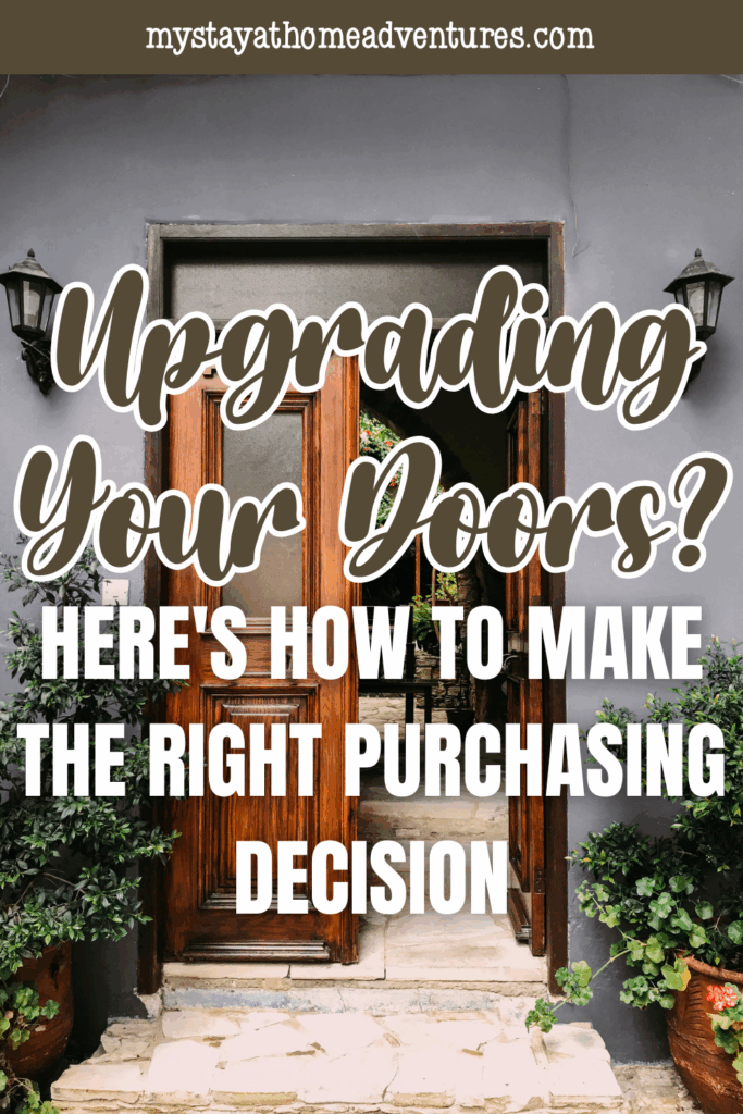 A wooden front door open to a stone walkway, surrounded by plants and exterior lighting.