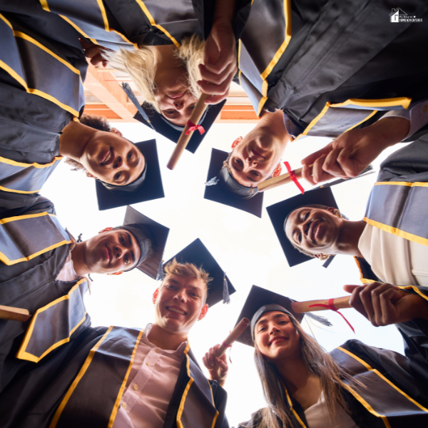 A group of diverse graduates in caps and gowns, symbolizing successful completion of the IB program.