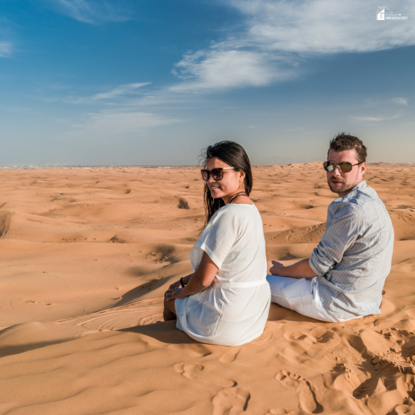 Couple enjoying a peaceful moment in the Dubai desert, capturing the relaxing side of an authentic desert safari experience.