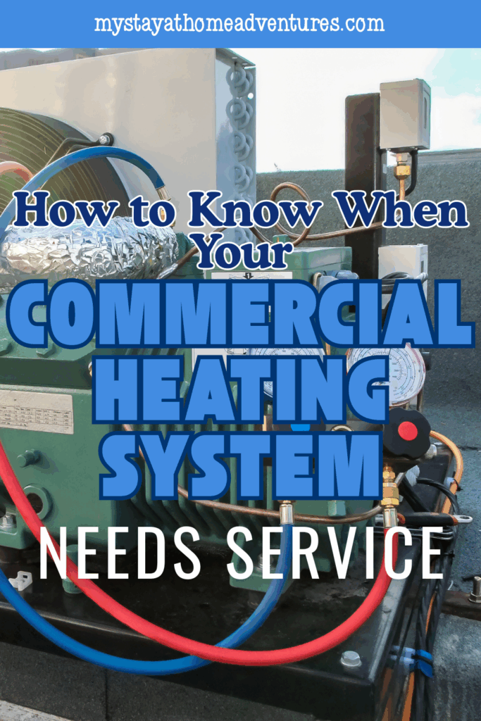 Close-up view of a rooftop commercial heating system with connected hoses and gauges during maintenance.