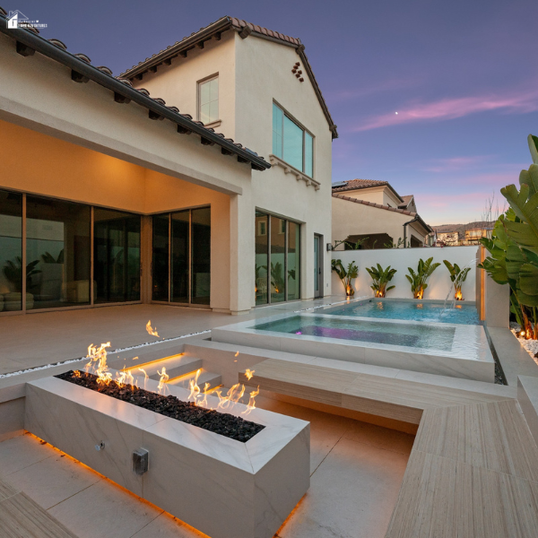 Custom pool design showcasing a sleek combination of modern water elements and a linear fire feature for visual contrast.
