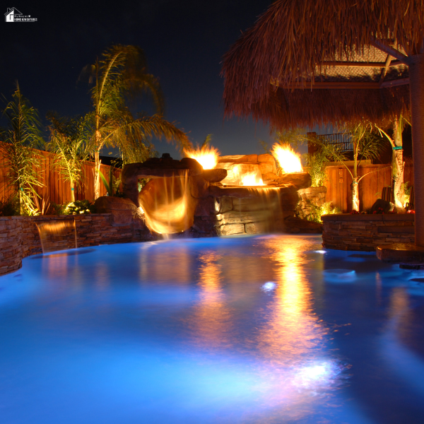 Backyard pool design blending dramatic fire bowls and cascading waterfalls to highlight the harmony of fire and water features.