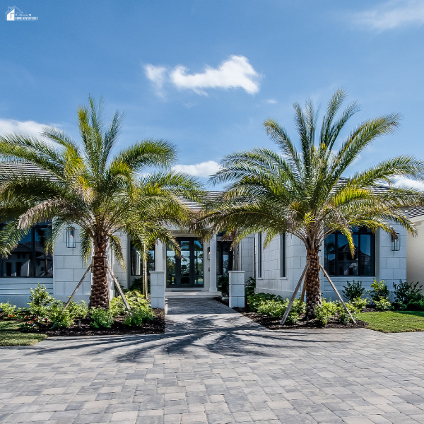 A modern home framed by palm trees and a wide driveway, reflecting residential choices buyers review while learning about financial assistance and eligibility.