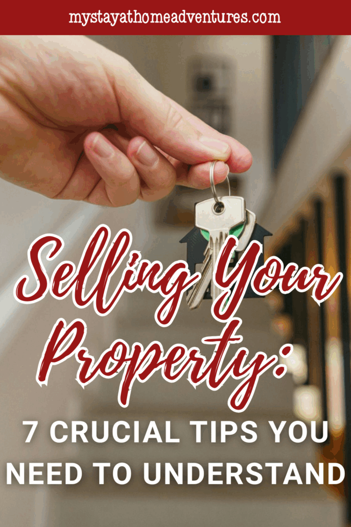 A hand holds a set of house keys indoors, symbolizing the successful sale and transfer of property ownership.