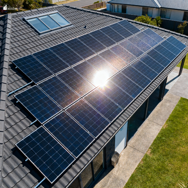 Large solar panel system installed on a modern home with a dark gray tile roof, reflecting efficient energy use for big households.