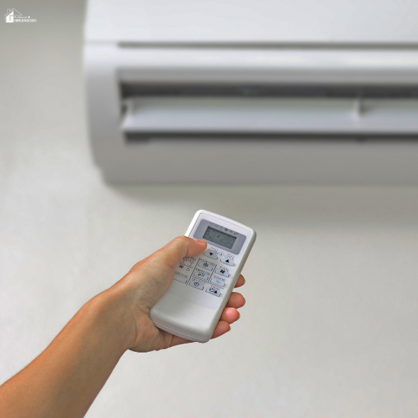A person using a remote to control a split system air conditioner that may not be responding properly—an issue worth attention.
