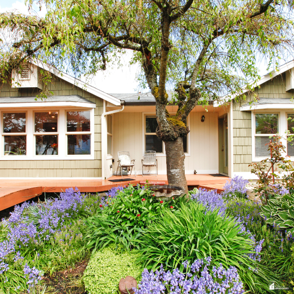 Charming home exterior with blooming landscaping and a well-kept yard, demonstrating simple, affordable ways to boost curb appeal.