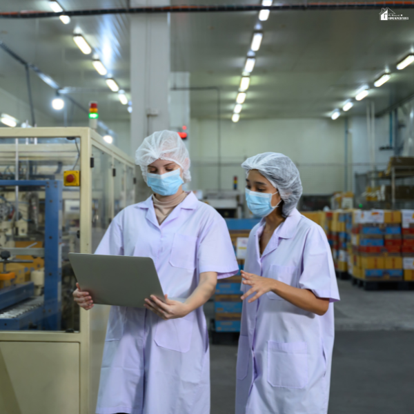 Food production professionals reviewing digital data inside a controlled commercial facility designed for sustainable food production operations.