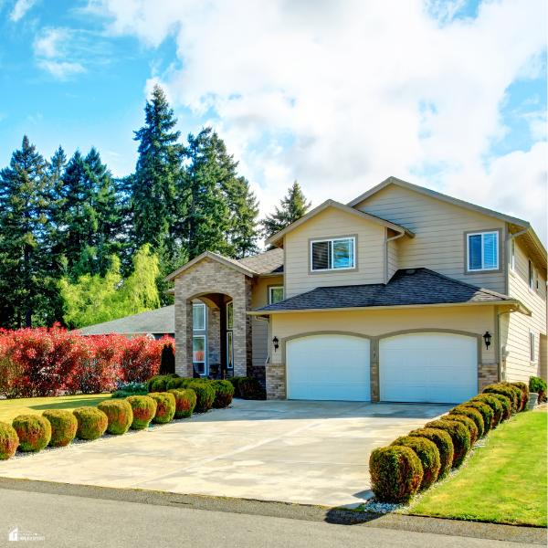 Well-maintained suburban home with trimmed hedges, clean driveway, and neat landscaping showcasing family-friendly curb appeal improvements.
