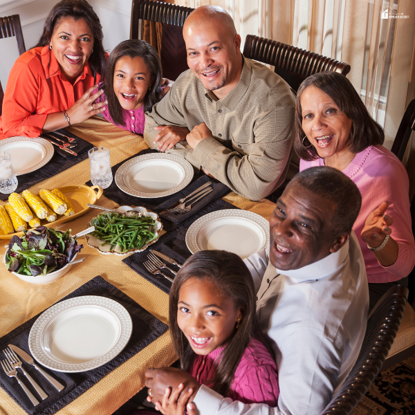 Extended family seated closely at a dinner table, illustrating how restaurant chairs offer durable and comfortable seating for hosting large gatherings.