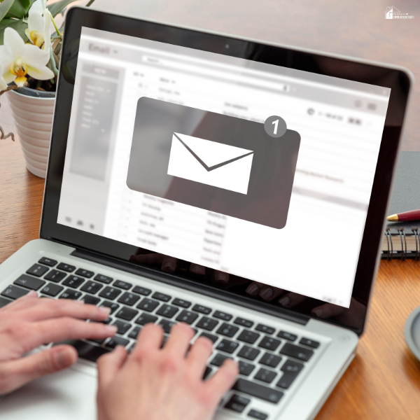 Laptop displaying an email notification while someone types, illustrating the use of technology to stay informed and manage online communication risks.