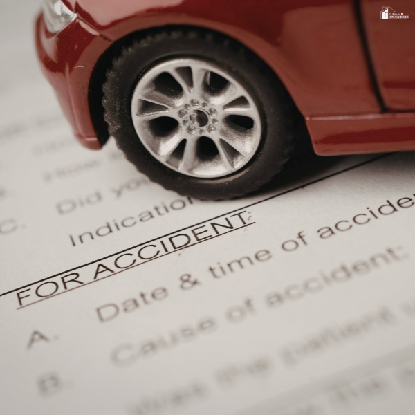 Close-up of a toy car on an accident claim form, representing financial protection considerations when evaluating personal accident coverage.