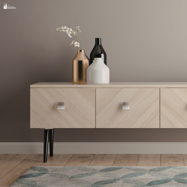 Minimalist wooden sideboard with closed drawers and decorative vases on top, showing stylish hidden storage that keeps surfaces clean and uncluttered.