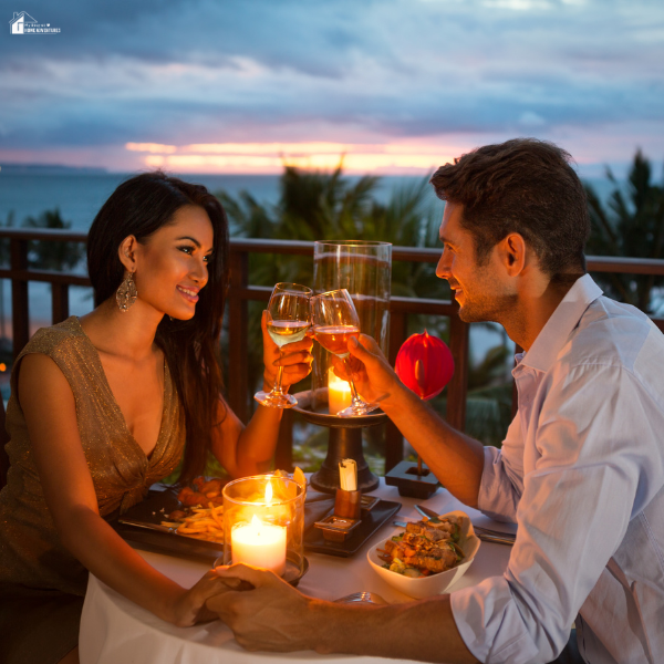 A couple shares a candlelit dinner by the ocean, illustrating how meaningful experiences create lasting memories over material gifts.