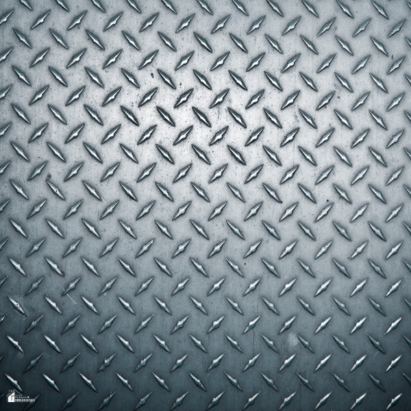 Close-up of aluminium checker plate flooring, highlighting a non-slip and durable surface ideal for dog wash stations.