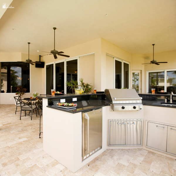 Covered patio with a built-in grill, countertop workspace, and seating area showing a stylish outdoor cooking space for backyard meals.