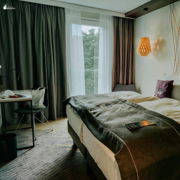 Bedroom with layered sheer and blackout curtains creating a cozy atmosphere with controlled lighting and added privacy.