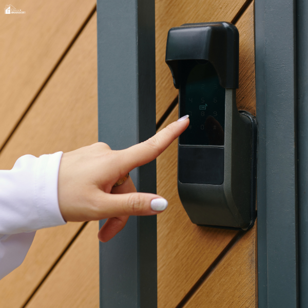Person entering a code on a modern digital door lock to improve household security and prevent unauthorized entry.
