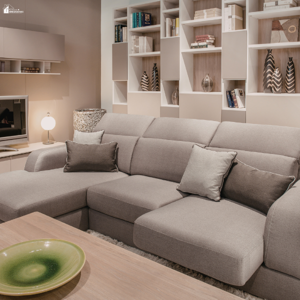 Modern living room with a large sectional sofa and built-in shelving illustrating a cozy conversation pit style seating area.