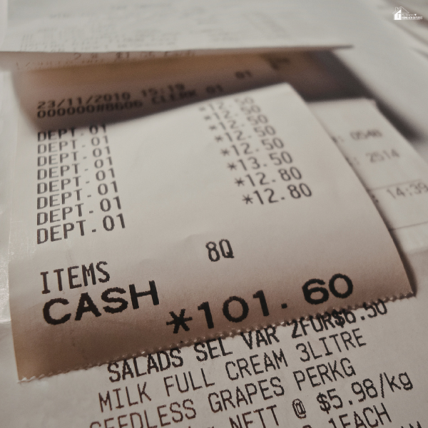 Close-up of a receipt with listed expenses, highlighting tracking spending and making small changes to save money.