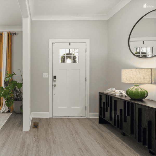 Bright and tidy entryway with a front door and organized space that supports a smooth and functional home setup.