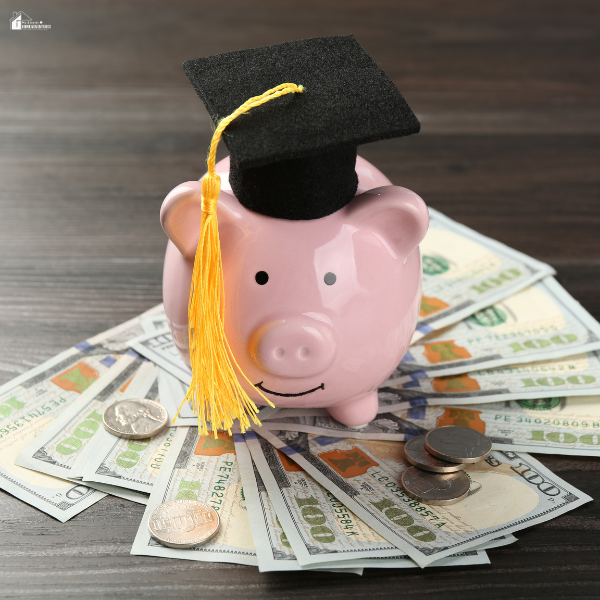 Pink piggy bank wearing a graduation cap sitting on cash and coins, representing saving money to pay for college tuition.
