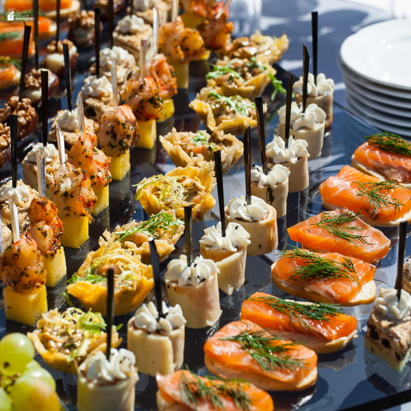 Assorted bite-sized appetizers including seafood, wraps, and canapés arranged on a tray for an Atlanta catering spread.