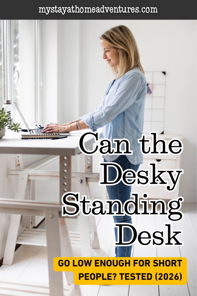 Woman using a height-adjustable standing desk near a window, representing Desky standing desk testing for short people in 2026.