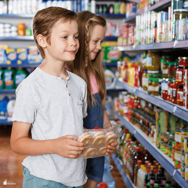 Two children shopping in a grocery store choosing affordable food items to help busy moms save money without sacrificing quality.