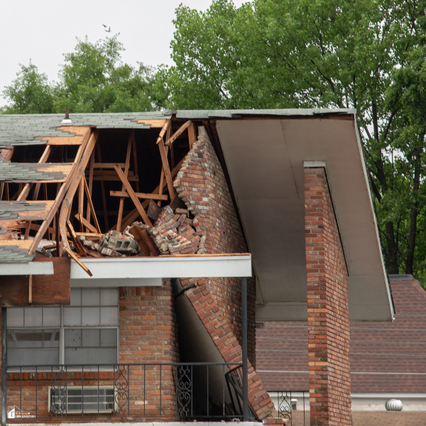Building with collapsed roof and broken brickwork, highlighting structural vs cosmetic damage insurers may classify differently.