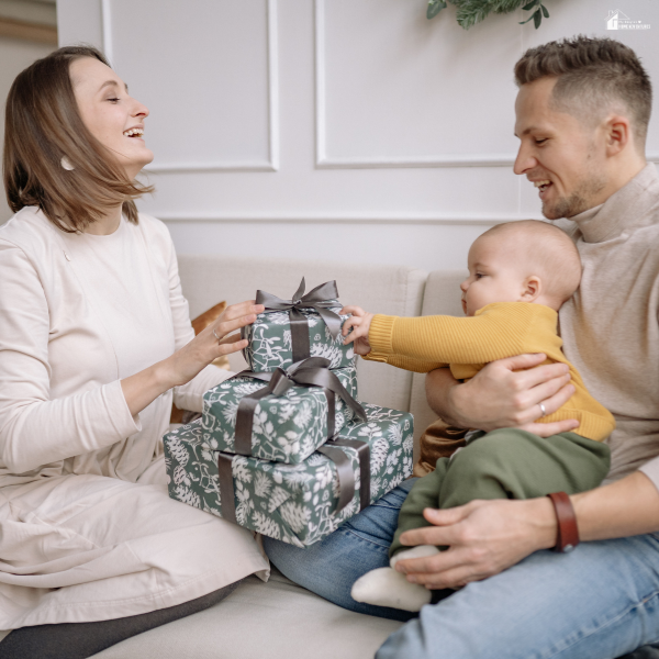 Family sitting together exchanging wrapped gifts, showing simple and meaningful Father’s Day gifting ideas for a relaxed celebration.