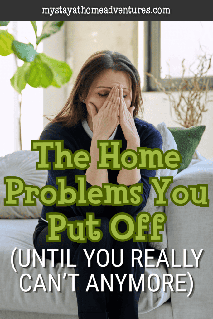 Overwhelmed homeowner sitting on couch covering face, representing stress caused by putting off important home repairs.