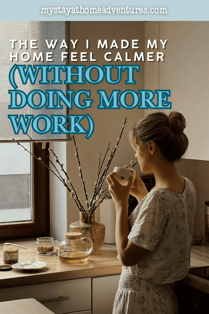 Woman enjoying a quiet moment with a warm drink in a tidy kitchen, representing a calm home created through simple and manageable habits.
