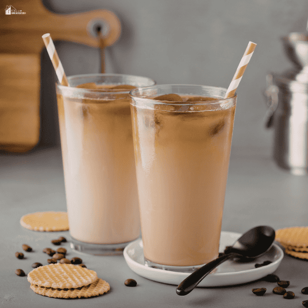 Two creamy iced coffee drinks in glass cups with striped paper straws, perfect for beverage pairings with sugared paper straws.