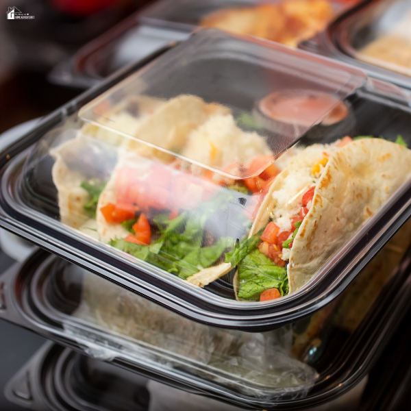 Affordable meal in a takeout container, showing budget-friendly food options while traveling.