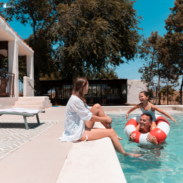 Family enjoying a backyard swimming pool, showing why pool leak detection helps keep pools ready for summer fun and safe use.